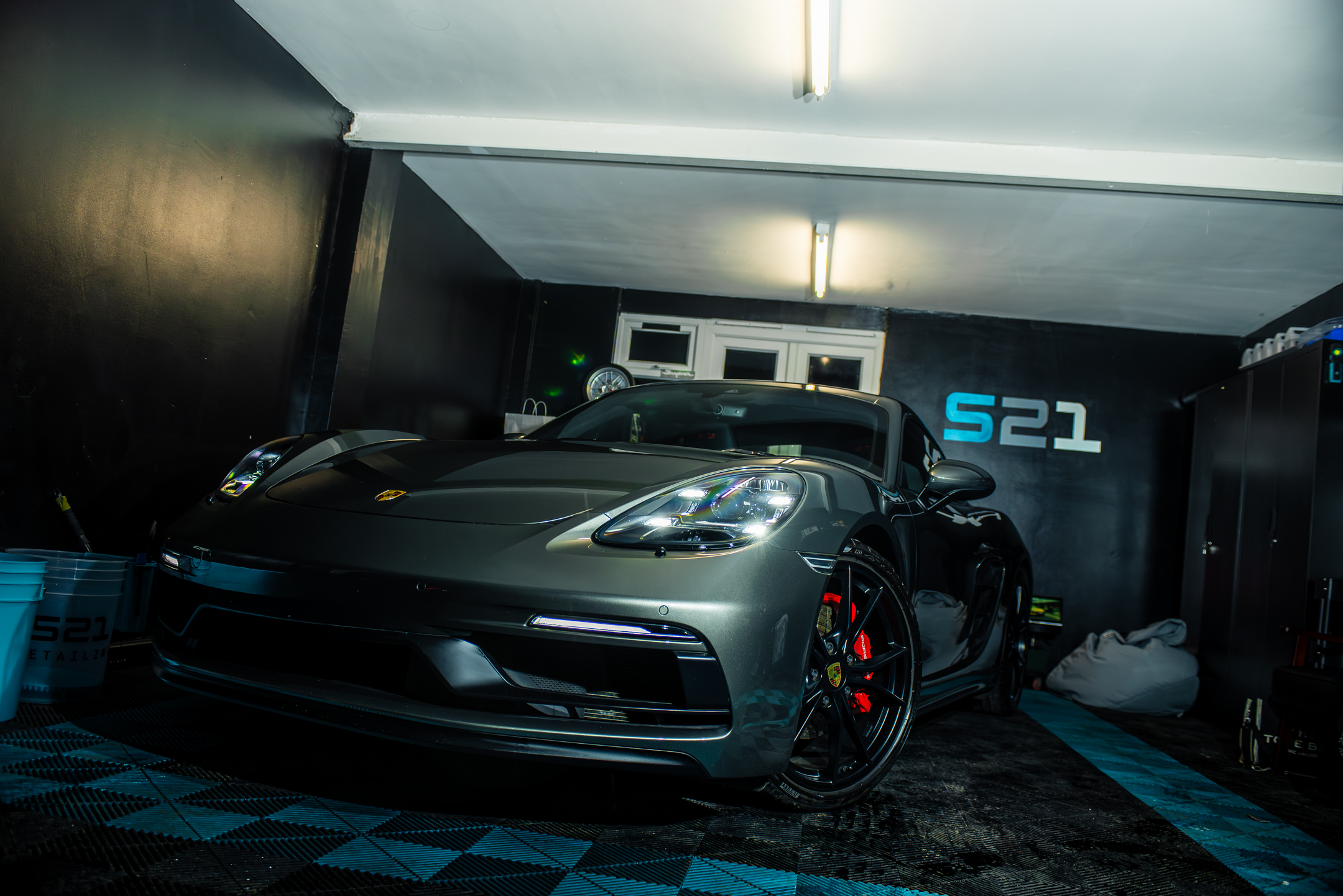 Detailed Porsche with headlights on in the S21 studio